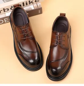 Top view of men's brown leather dress shoes with gradient finish and carved details.