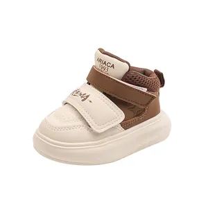 Detailed side view of toddler sports shoes in brown and beige with dual velcro straps