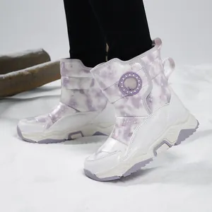 Children's purple and white cloud pattern winter snow boots on snowy ground