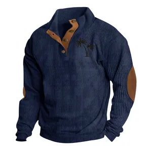 Detail of navy ribbed corduroy sweatshirt with palm tree print and brown elbow patches.