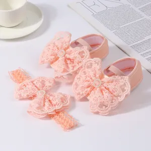 Detail of baby girl pink princess shoes and headband set with lace bows and pearls