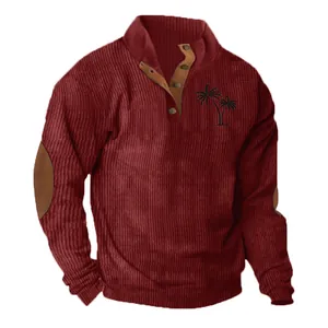 Close-up of men's burgundy corduroy sweatshirt with palm tree print and elbow patches