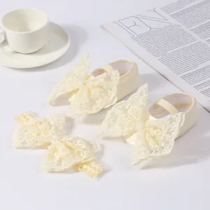 Close-up of baby girl lace bow shoes and matching headband set for special occasions