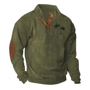 Detail of olive green corduroy sweatshirt showing palm tree print and elbow patches.