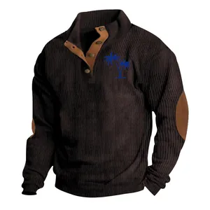 Detailed view of brown corduroy sweatshirt featuring blue palm tree embroidery