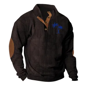 Close-up of brown corduroy men's shirt featuring blue palm tree embroidery detail
