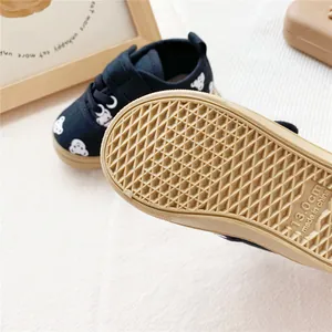 Detailed view of the anti-slip waffle rubber sole on kids' bear pattern canvas sneakers