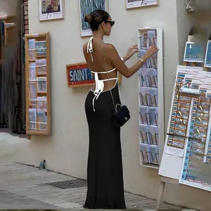 Elegant backless halter-neck black knitted maxi dress featuring white contrast tie straps
