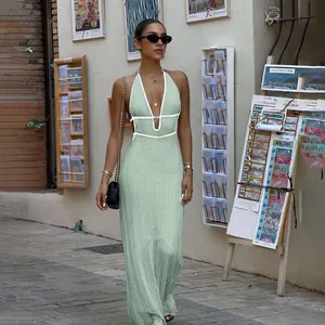 Elegant mint green knit maxi dress with white contrast V-neck and stylish halter design.