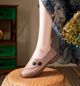 Close-up detail of soft leather flat walking shoes for elderly women with vintage knot decoration