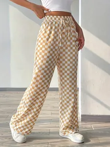 Close-up detail of women's trendy checkered wide-leg pants with high-waist drawstring