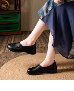 Elegant black leather shoes for women featuring soft soles and vintage button detail