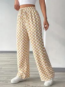High-waisted checkered wide-leg pants in tan and white, featuring a drawstring waist