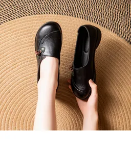 Detailed view of women's soft black leather loafers with non-slip flat soles and round toe