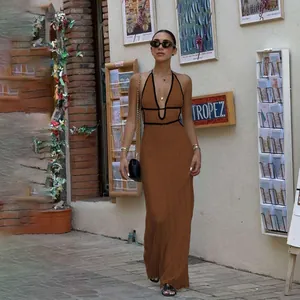 Chic brown knitted halter maxi dress with black trim in a street style setting