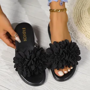 Sandali bassi neri da donna con grande decorazione floreale 3D sul cinturino
