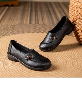 Close-up view of black slip-on flat leather shoes for elderly women with soft soles