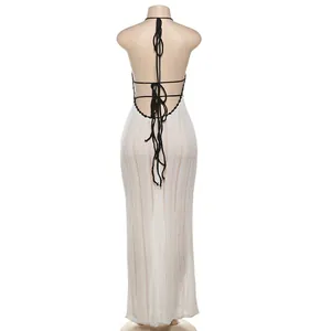 Detailed back view of white knit maxi dress with contrast black halter ties and backless design