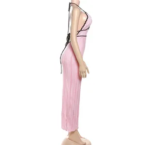 Detailed side view of pink knit halter maxi dress with black lace-up back design.