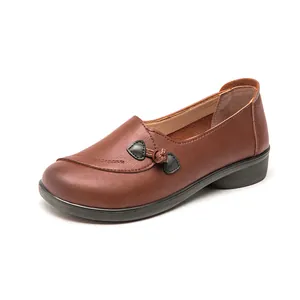 Comfortable brown leather loafers for elderly women with a decorative side heart knot.