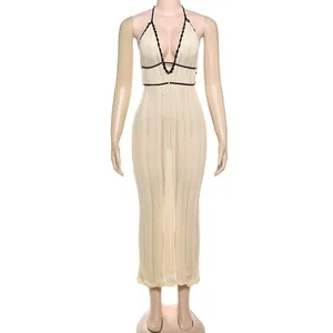 Close-up of elegant halter neck knitted maxi dress with contrast black trim detailing