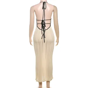 Detailed back view of a beige knit halter maxi dress featuring elegant black tie straps
