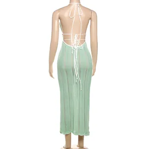 Back view of a mint green knitted halter-neck dress with lace-up backless detail
