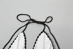 Close-up detail showing the black halter neck tie on a white crochet knit dress