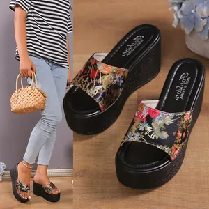 Detailed view of floral wedge sandals with comfortable thick platform sole for summer style.
