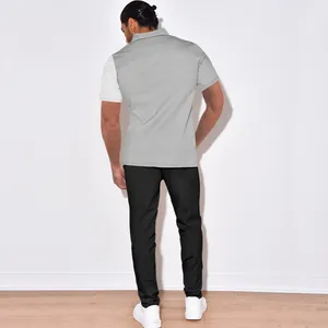 Back view of men's grey and white color-blocked corduroy short sleeve shirt and pants set