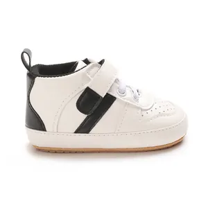 Detailed side view of white baby walking shoes with soft soles and black accents