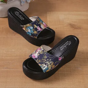 High-quality detailed view of floral pattern wedge slides with thick black platform sole