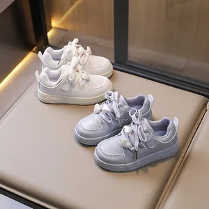 Fashionable girls white and blue sports sneakers with cute heart ornaments for school