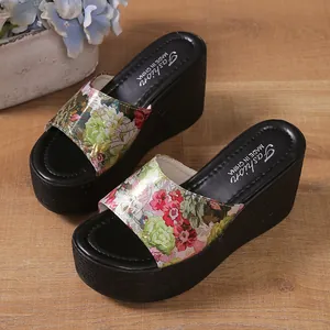 Macro view of floral print straps on platform wedge sandals with black sole
