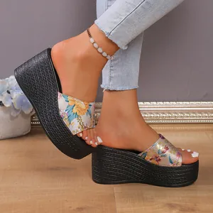 Macro detail view of floral pattern wedge platform sandals featuring black braided sole texture