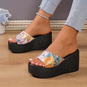 Macro detail of the colorful floral pattern strap on these high platform wedge sandals