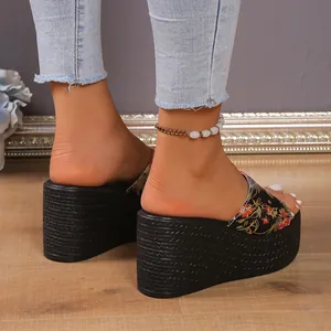 Close-up of bohemian floral wedge platform slippers with thick woven texture soles