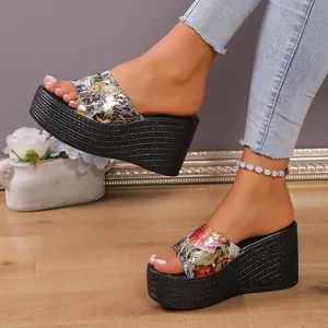 Detailed view of women's floral print wedge slippers with textured platform soles
