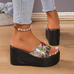 Detail view of women's platform wedge slides featuring a vibrant floral print upper