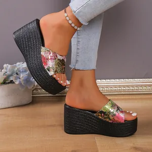 Stylish floral print wedge slides with thick black textured platform sole for summer.