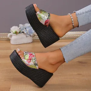 Stylish platform wedge mules with vibrant floral pattern and braided sole detail