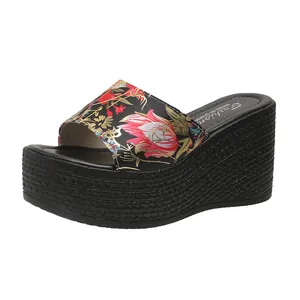 Detailed side profile of women's floral wedge platform sandal with woven rope sole