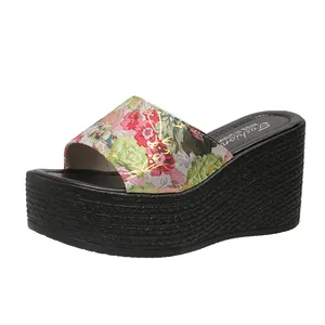 Detailed view of women floral wedge sandals featuring thick black braided platform soles