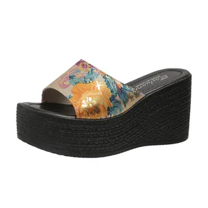 Side view of women's floral platform wedge slippers with thick textured sole