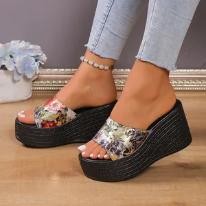 Stylish women's platform wedge slides with vibrant floral print and textured black soles.
