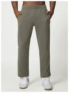Detailed front view of men's loose-fit grey casual sweatpants worn by a male model