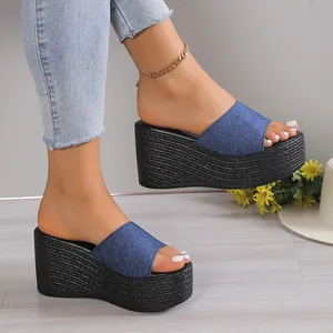 Side view of stylish blue denim platform wedge sandals with woven texture on a model