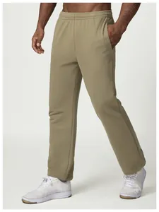 Model wearing olive green men's loose casual sweatpants in a dynamic walking pose