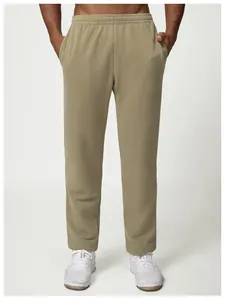 Front detail view of olive green loose-fit men's sweatpants for casual citywalk