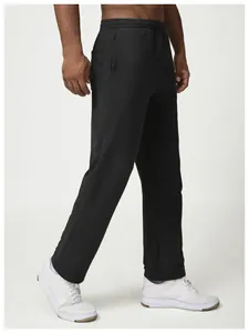 Detailed side view of black loose-fit men's sweatpants with elastic waist and pockets
